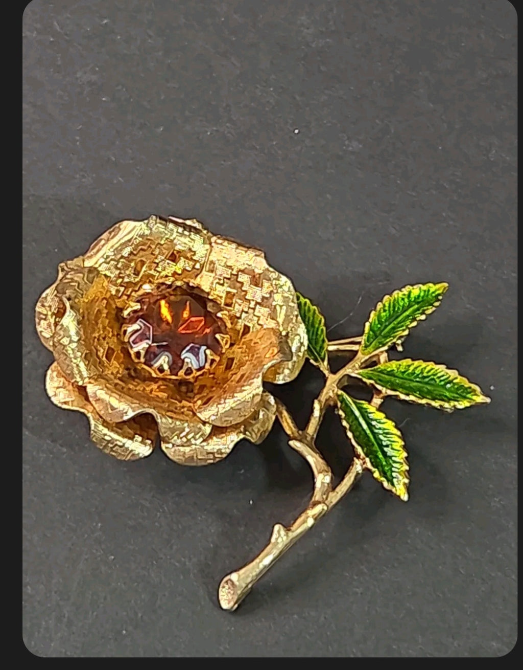 Oddly Darling Vintage gold-tone rose brooch with a faceted amber center stone and hand-enameled green leaves.