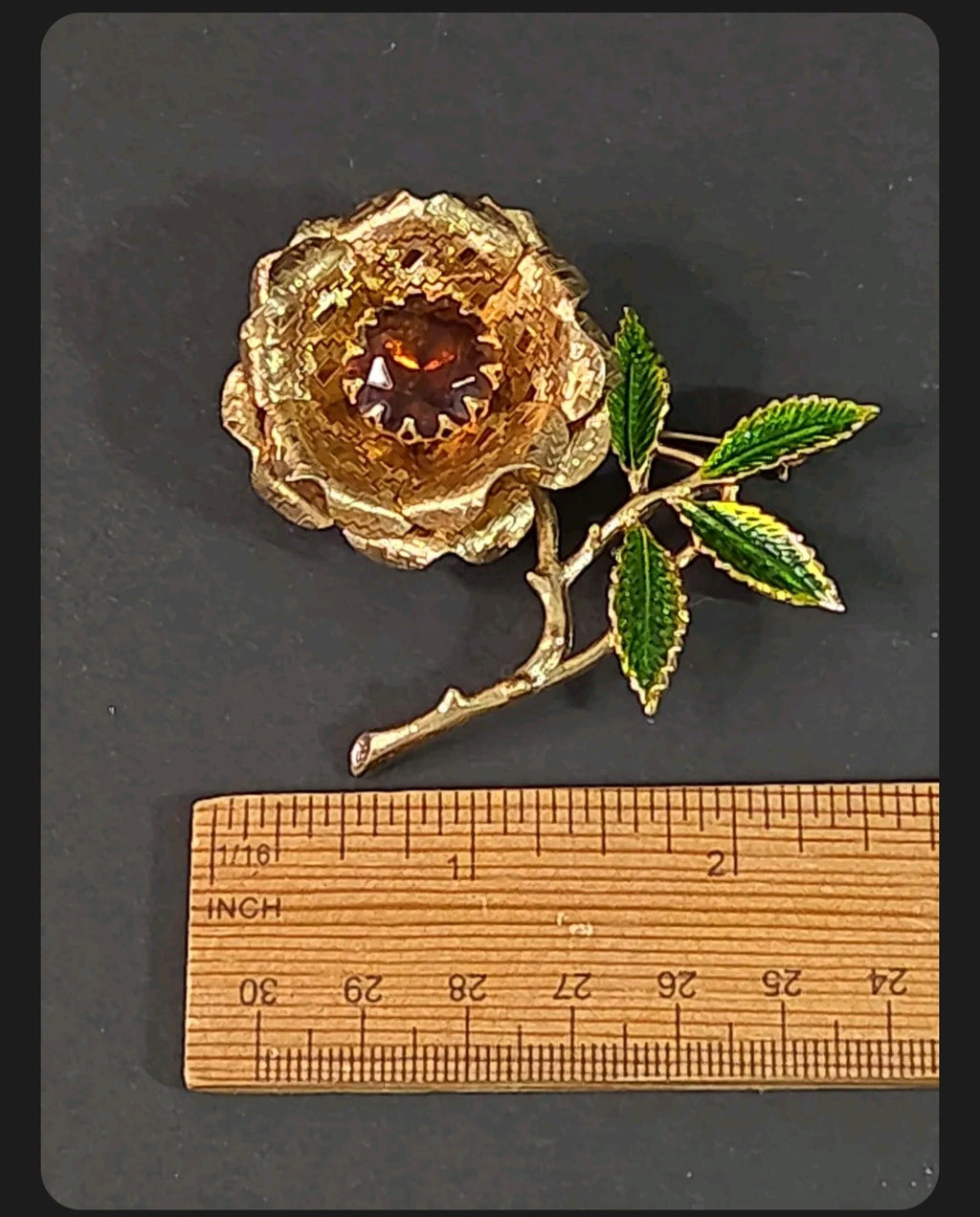 Oddly Darling Vintage gold-tone rose brooch with a deep amber center stone and hand-enameled green leaves