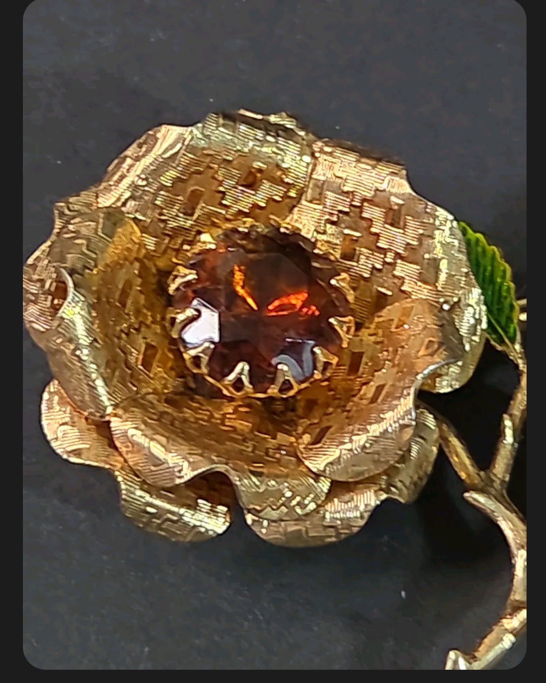 Oddly Darling Vintage gold-tone rose brooch with a faceted amber center stone and green enameled leaf detail.