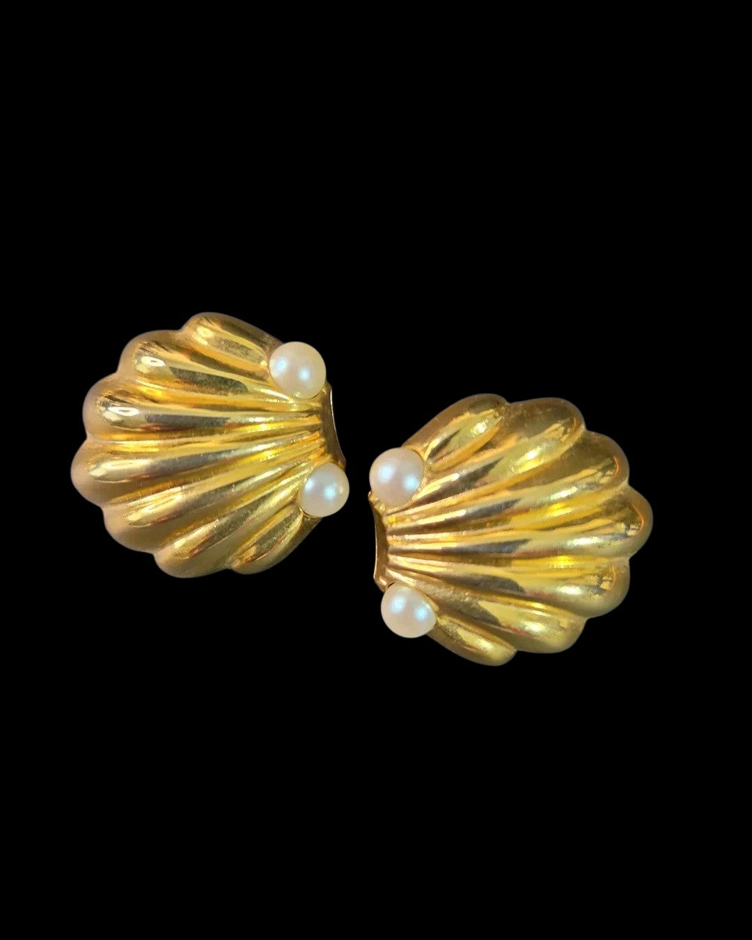 Oddly Darling Vintage gold-tone scalloped shell clip-on earrings with faux pearl accents on a black background