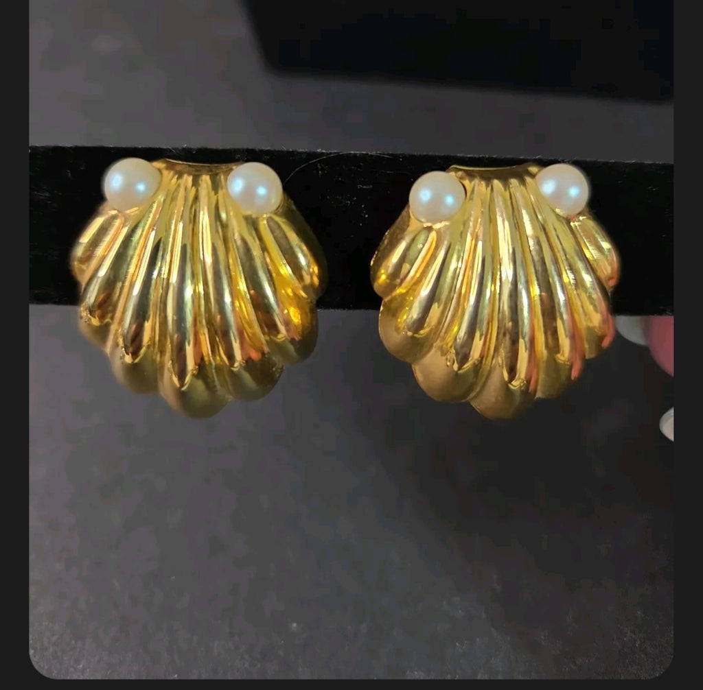 Oddly Darling Vintage gold-tone scalloped shell clip-on earrings with faux pearl accents on a black display stand.