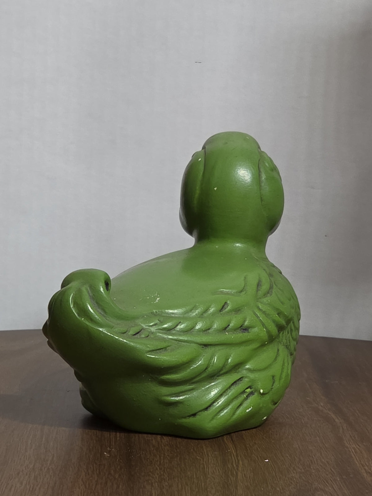 Oddly Darling Vintage matte green ceramic duck figurine with embossed feather details, viewed from the back.