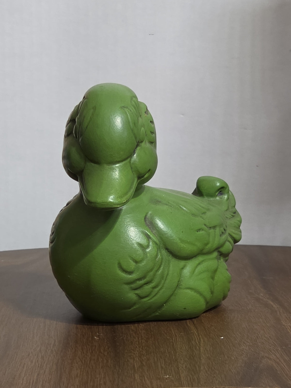 Oddly Darling Vintage matte green ceramic duck figurine with embossed feather details on a wooden surface.