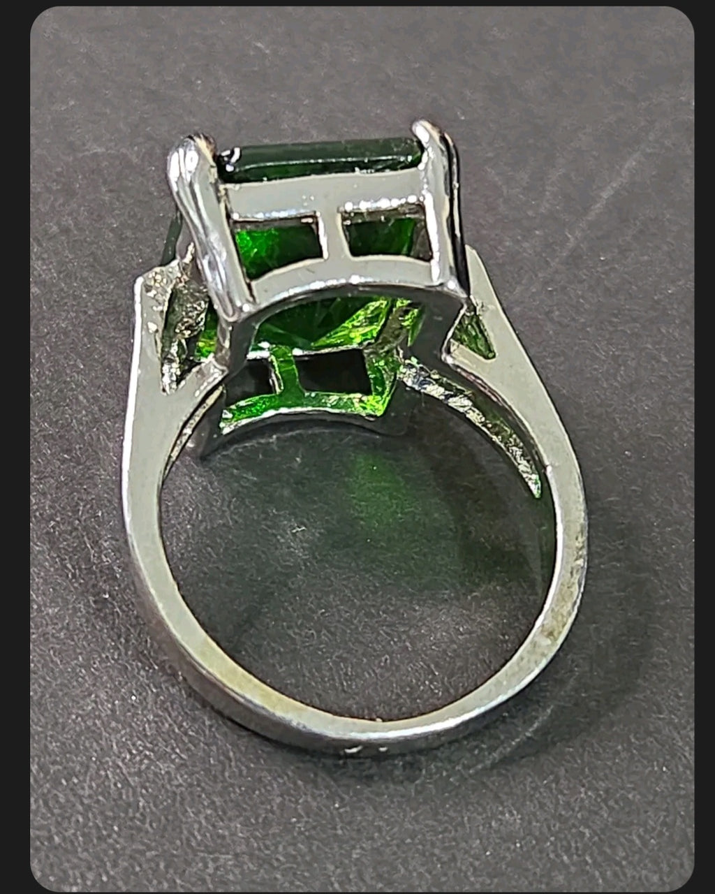 Oddly Darling Vintage statement ring featuring a large emerald-cut green gemstone in a polished silver-tone setting.