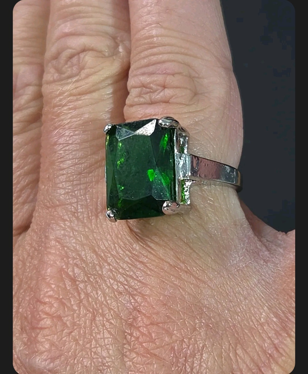 Oddly Darling Vintage statement ring featuring a large emerald-cut green gemstone in a polished silver-tone setting.