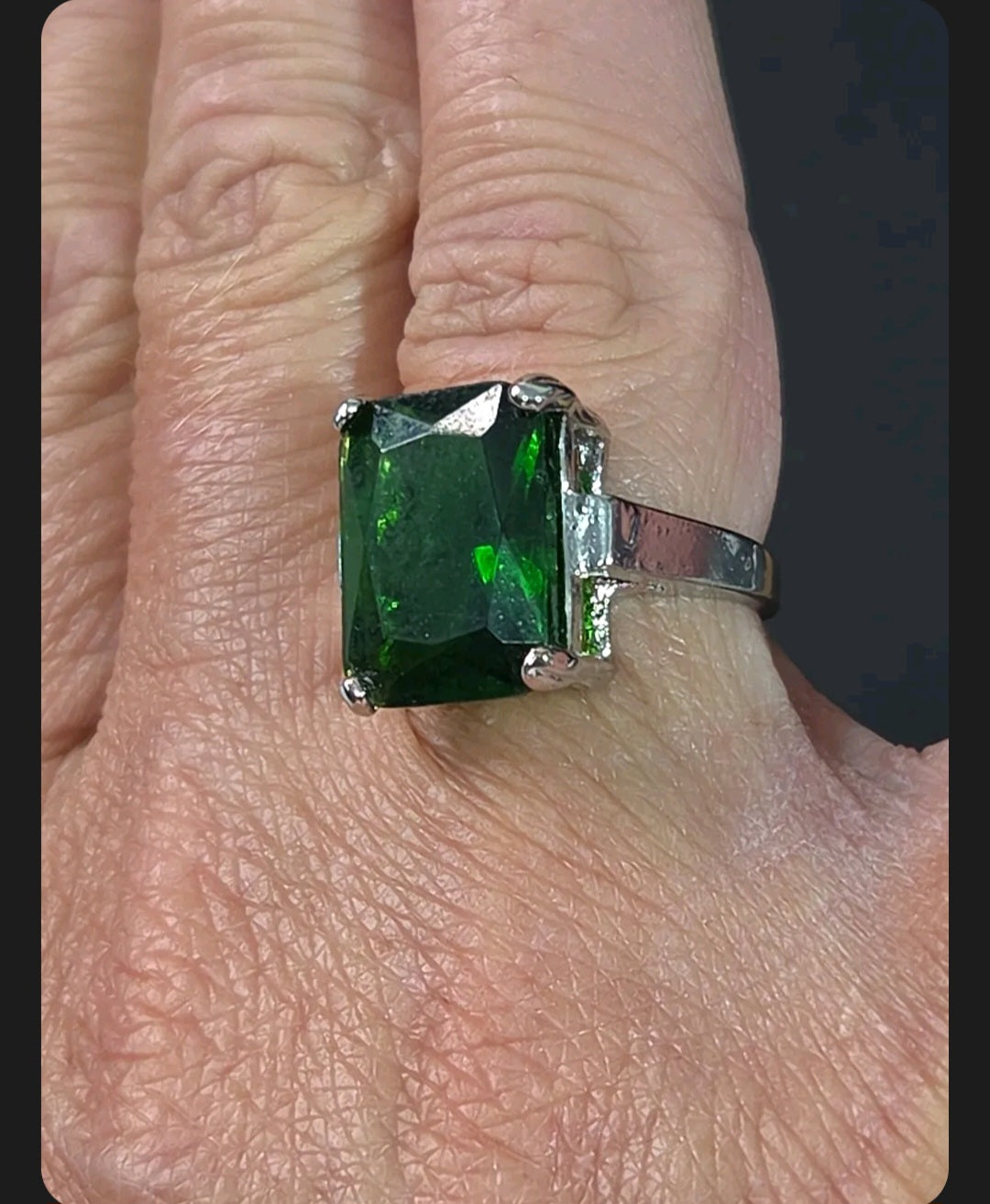 Oddly Darling Vintage statement ring featuring a large emerald-cut green gemstone in a polished silver-tone setting.