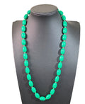Oddly Darling Vintage emerald green oval bead necklace with small gold-tone spacers on a black display bust.