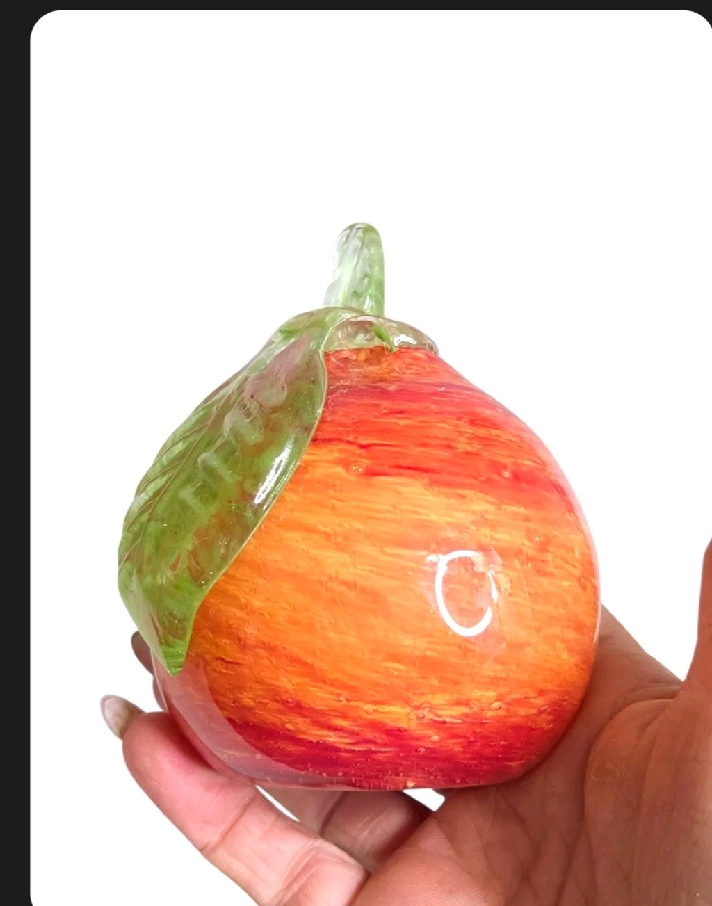 Oddly Darling Vintage hand blown glass fruit paperweight in sunset orange and red with a green glass leaf