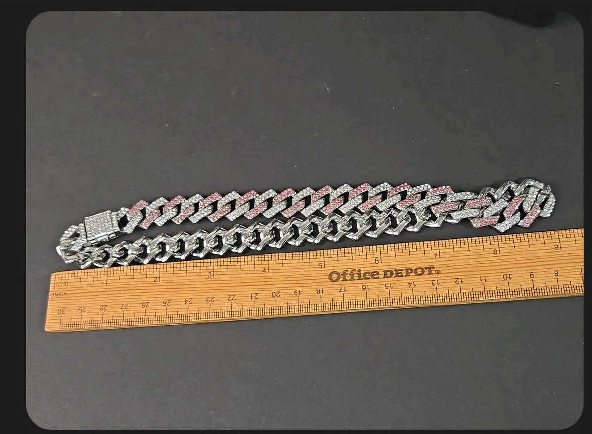 Oddly Darling Vintage iced-out cuban link necklace with alternating clear and pink stones on a dark background