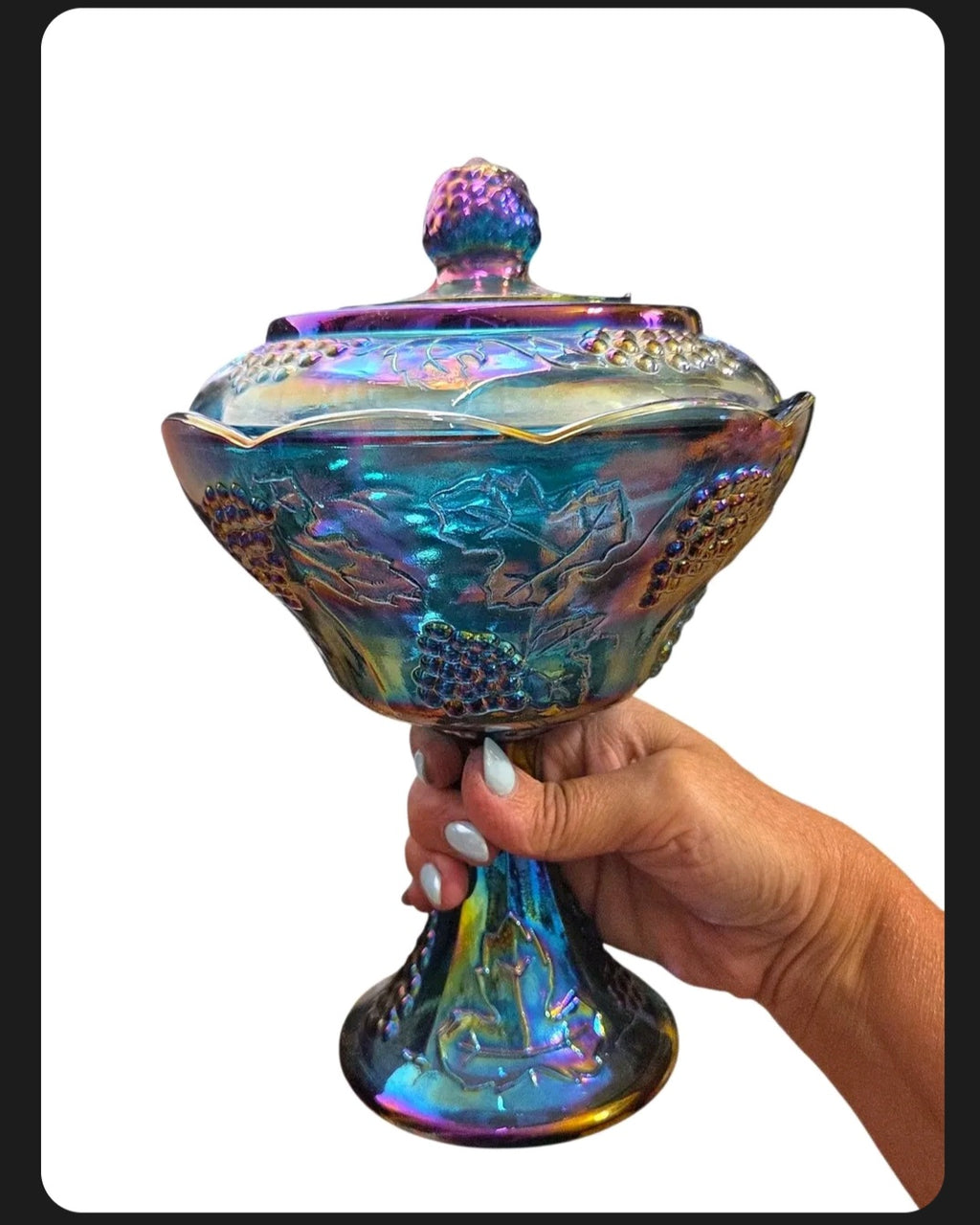 Oddly Darling Vintage iridescent carnival glass pedestal candy dish with lid featuring an embossed grape vine motif.