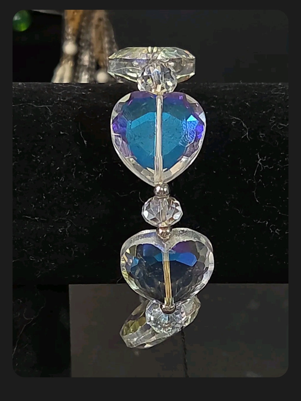 Oddly Darling Vintage stretch bracelet featuring iridescent faceted heart beads with blue and purple aurora reflections