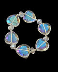 Oddly Darling Vintage stretch bracelet featuring iridescent faceted heart beads with blue and purple aurora reflections