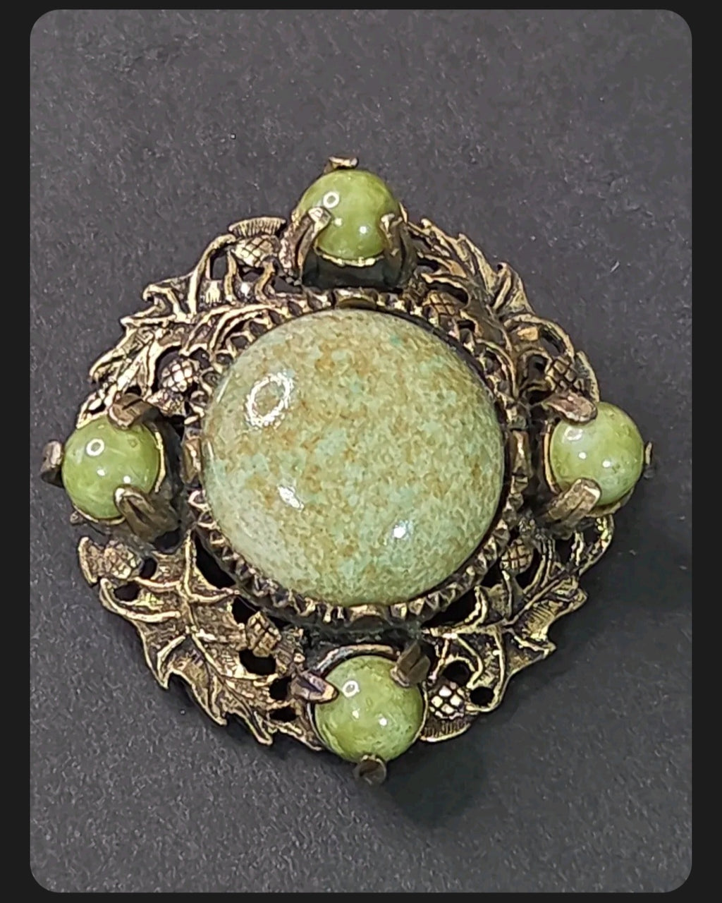 Oddly Darling Vintage Miracle brooch with sage-green mottled cabochons in an antique-gold leaf and acorn metal frame.