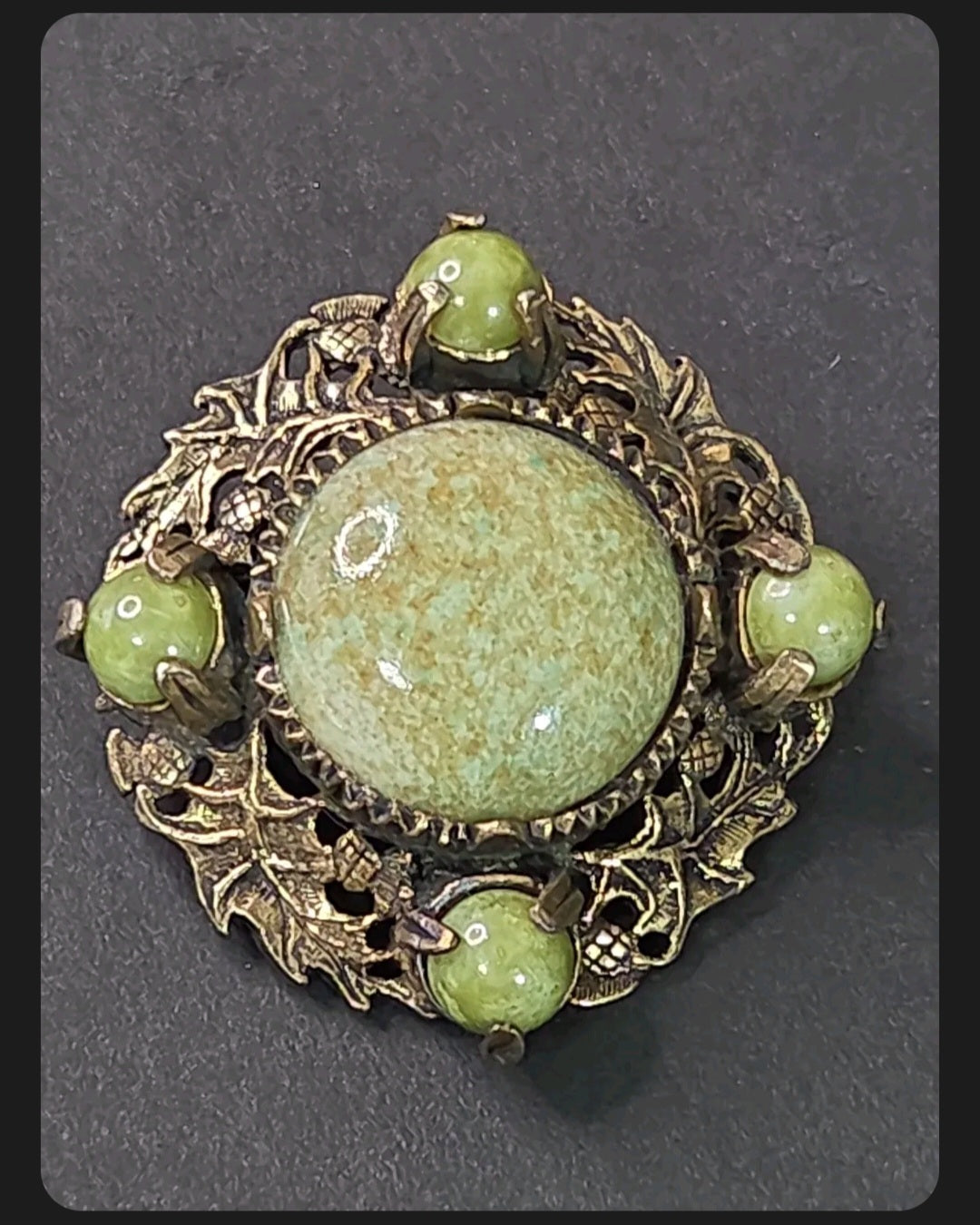 Oddly Darling Vintage Miracle brooch with sage-green mottled cabochons in an antique-gold leaf and acorn metal frame.