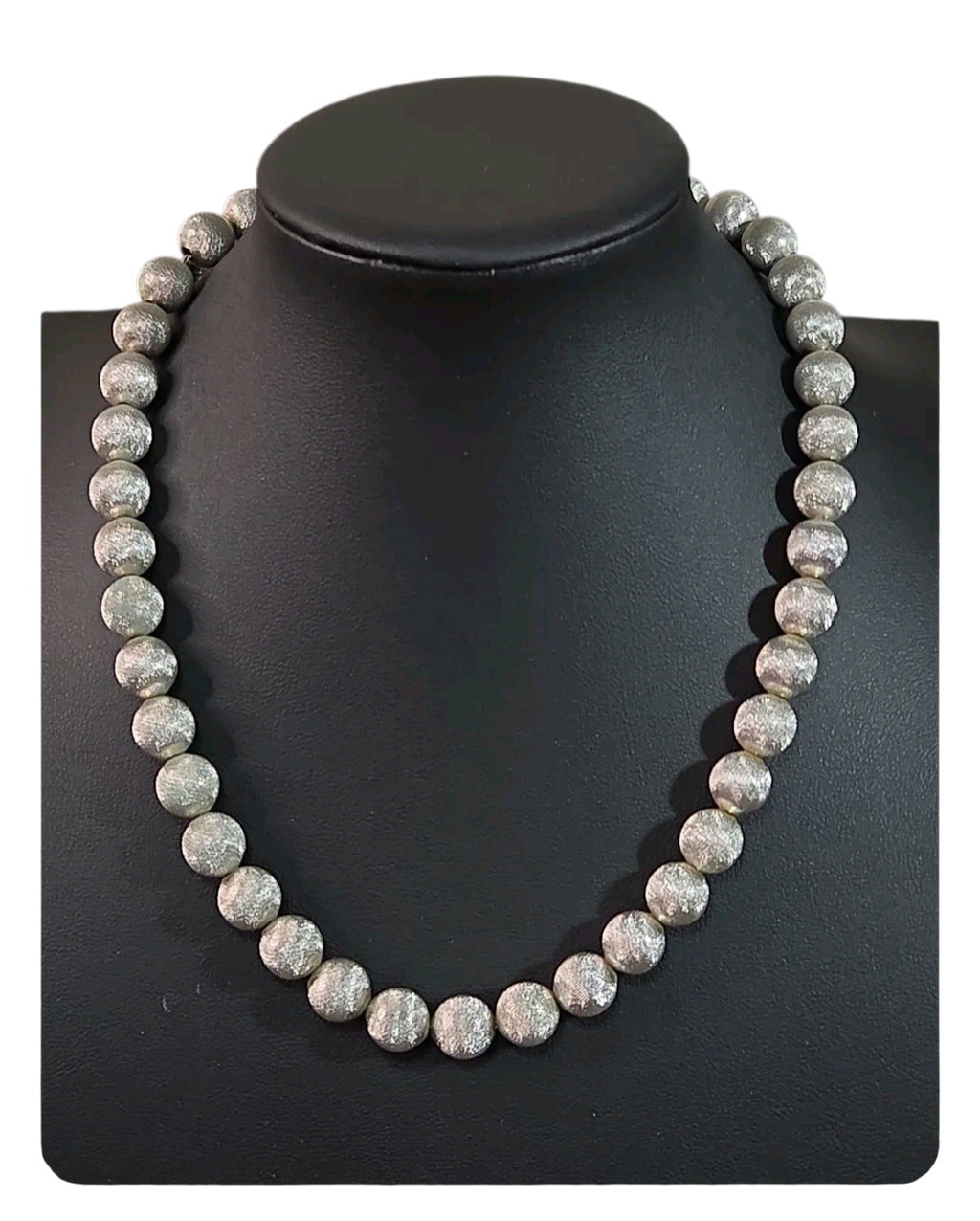 Oddly Darling Vintage Monet silver-tone statement necklace with textured spherical beads on a black display bust.