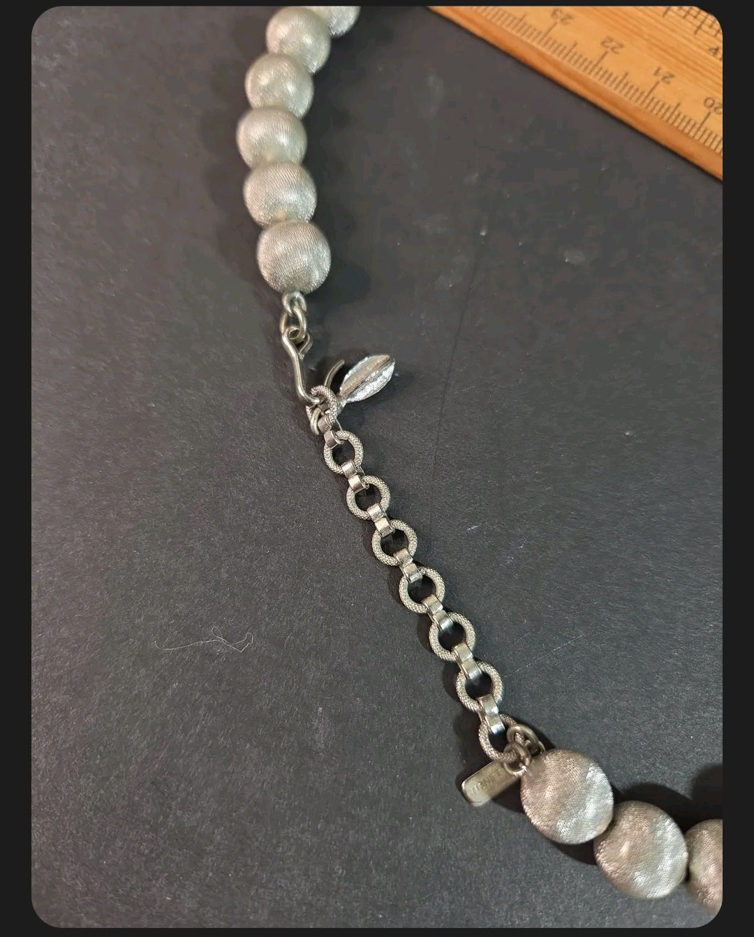 Oddly Darling Vintage Monet silver-tone statement necklace with textured spherical beads and adjustable chain clasp.