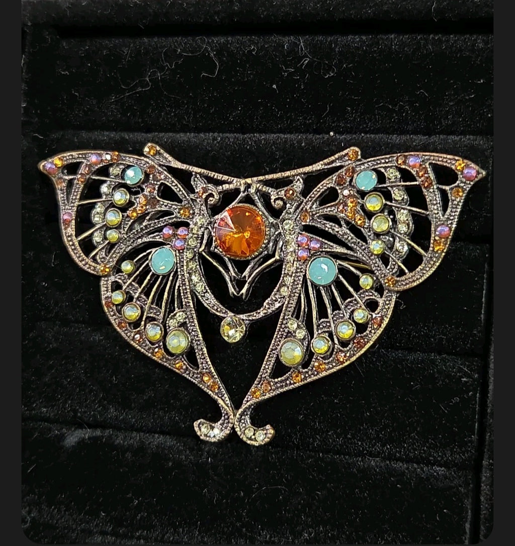 Oddly Darling Vintage ornate moth brooch in antique bronze with a central amber stone and multi-colored crystals.