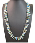 Oddly Darling Vintage multi-colored shell bead necklace with blue, green, and white elongated beads on a display bust.