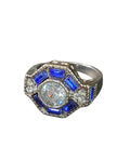 Oddly Darling Vintage ornate statement ring with a central round stone, blue baguette accents, and antique band.