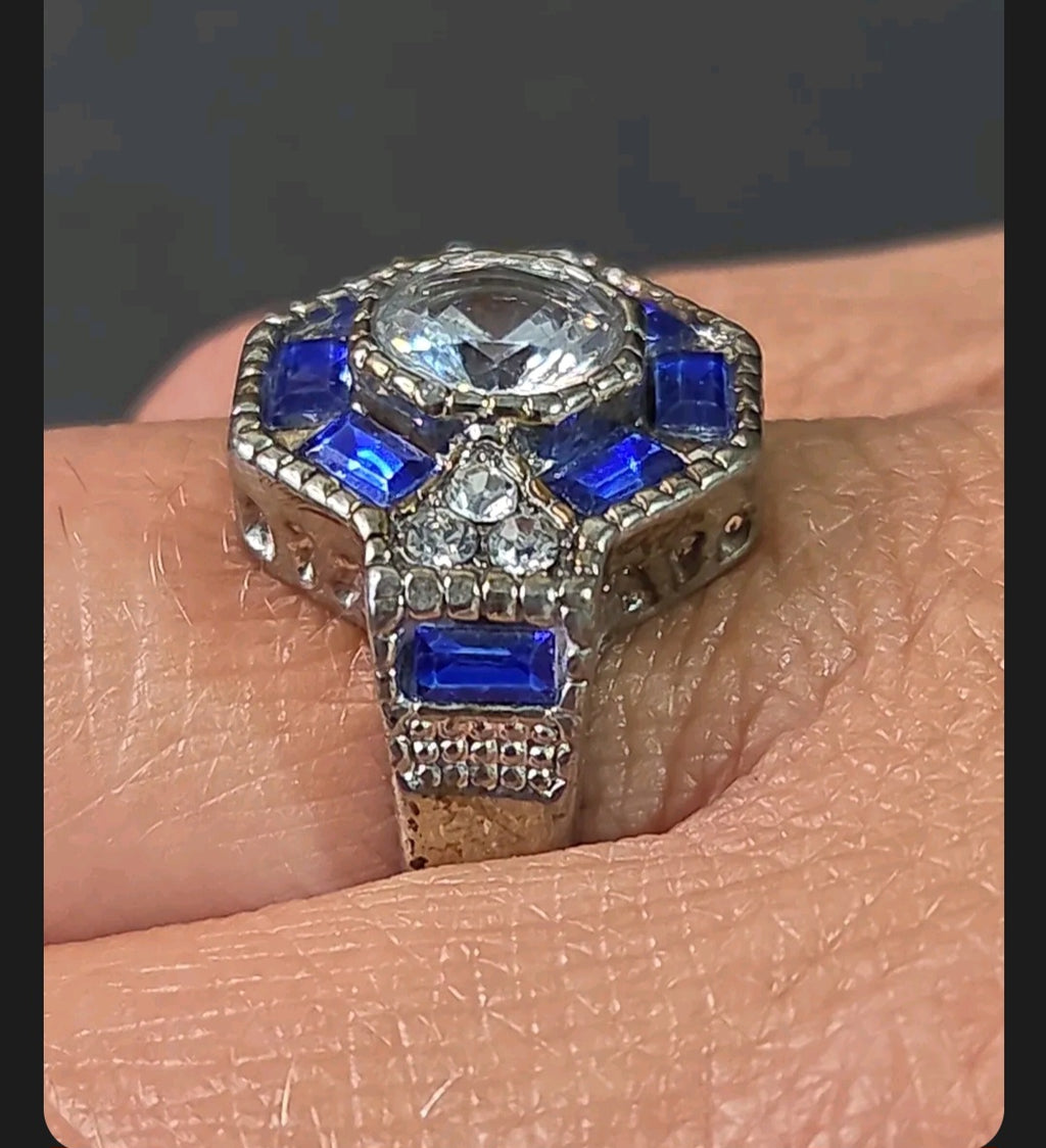Oddly Darling Vintage ornate statement ring with a central clear stone, blue baguette accents, and antique band.