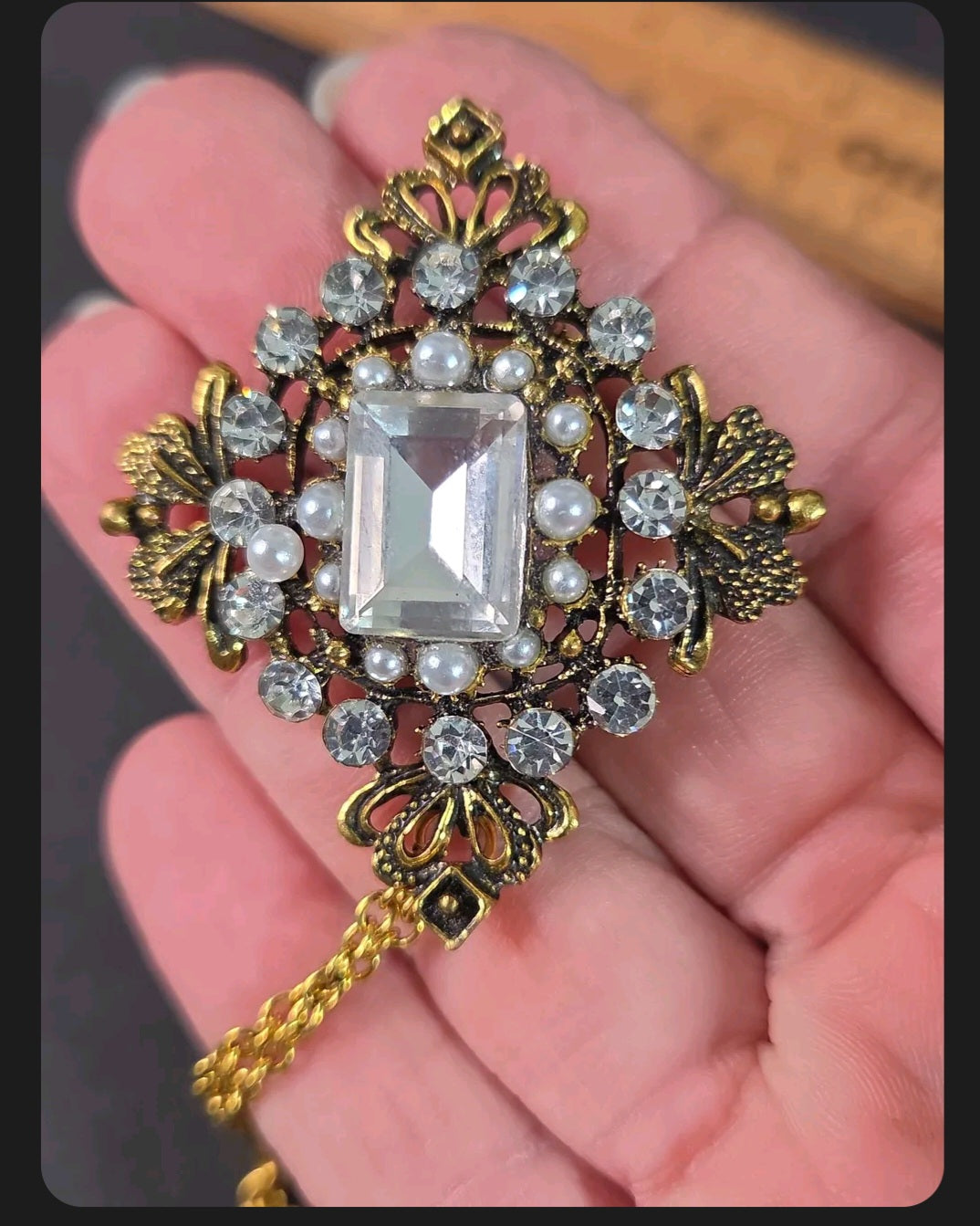 Oddly Darling Vintage ornate gold-tone brooch with a central rectangular crystal, clear rhinestones, and faux pearls.