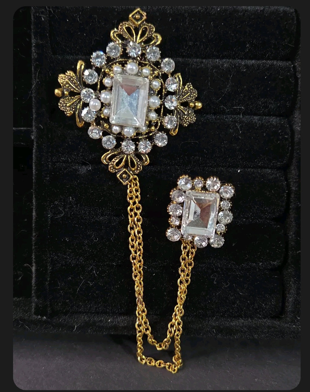 Oddly Darling Vintage ornate double brooch set with gold-tone chains, clear crystals, and faux pearls on black velvet.