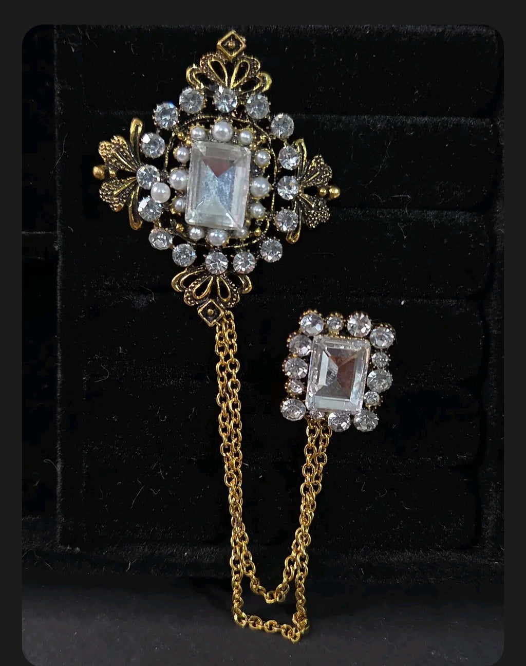 Oddly Darling Vintage ornate double brooch set with gold-tone chains, clear crystals, and faux pearls on black velvet.