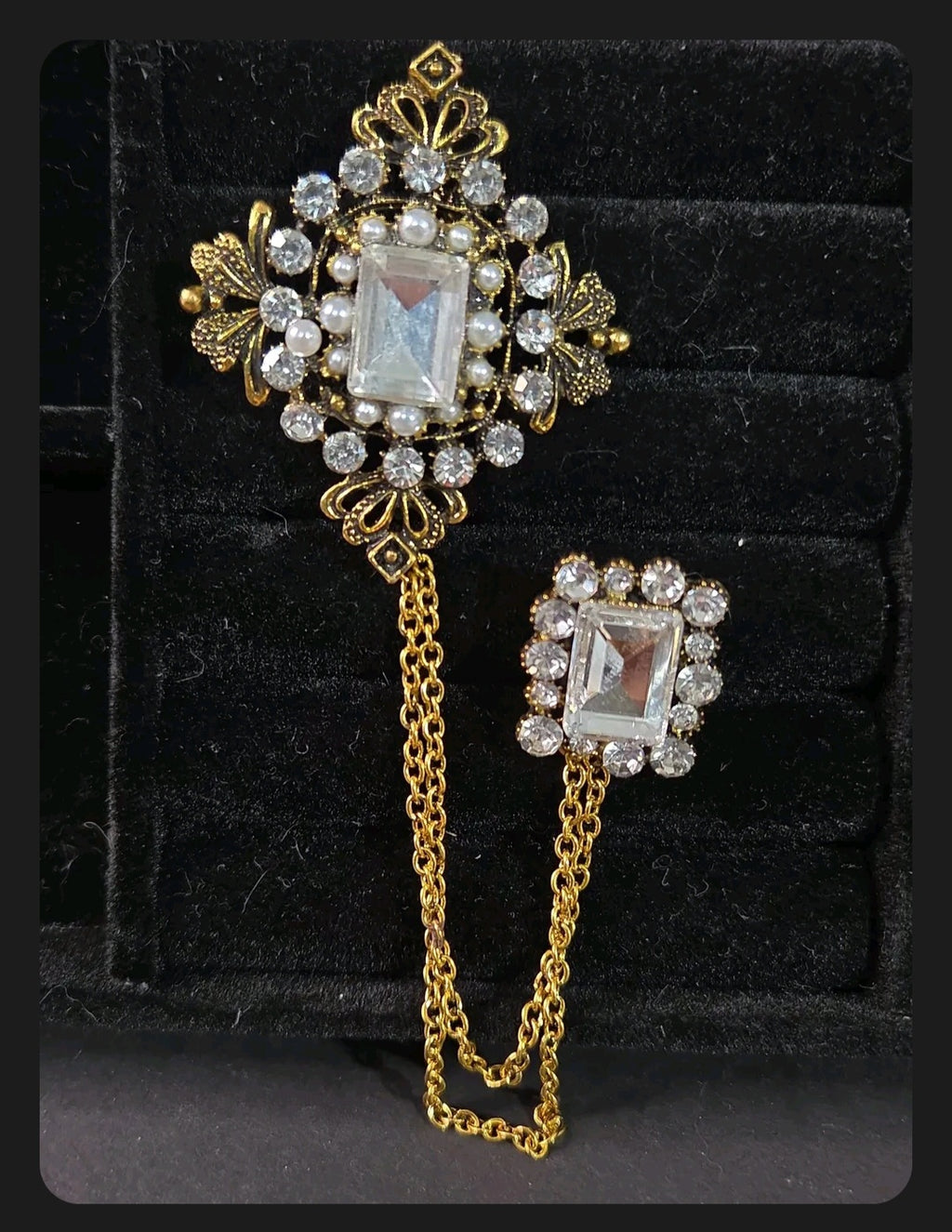 Oddly Darling Vintage ornate double brooch set with gold-tone chains, clear crystals, and faux pearls on black velvet.