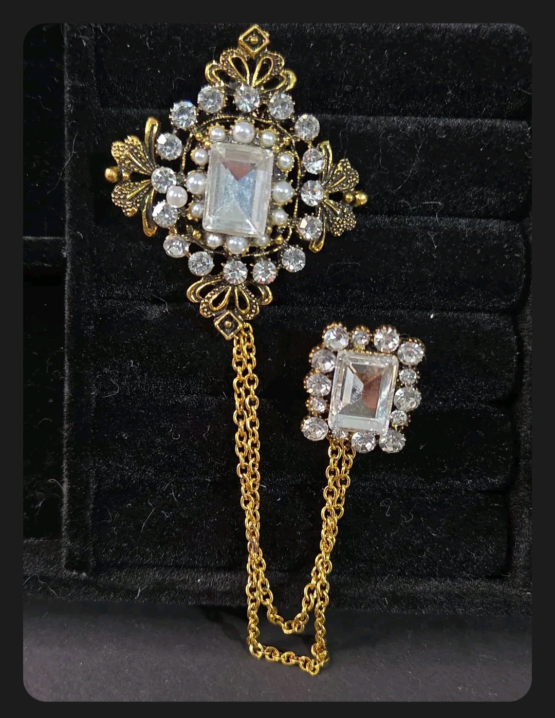 Oddly Darling Vintage ornate double brooch set with gold-tone chains, clear crystals, and faux pearls on black velvet.