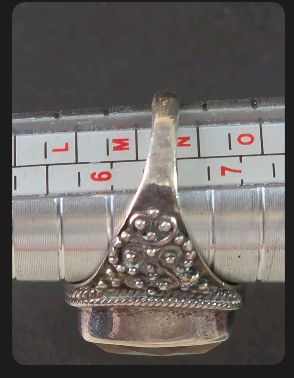 Oddly Darling Vintage ornate sterling silver statement ring with intricate granulation on a metal ring sizing mandrel