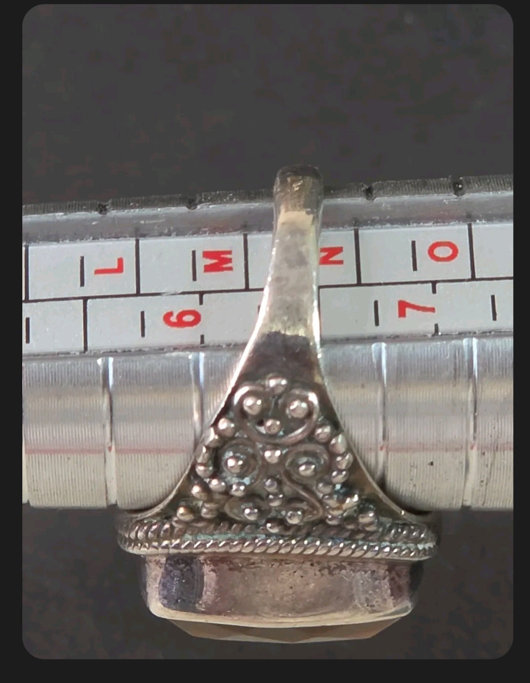 Oddly Darling Vintage ornate sterling silver statement ring with intricate granulation on a metal ring sizing mandrel