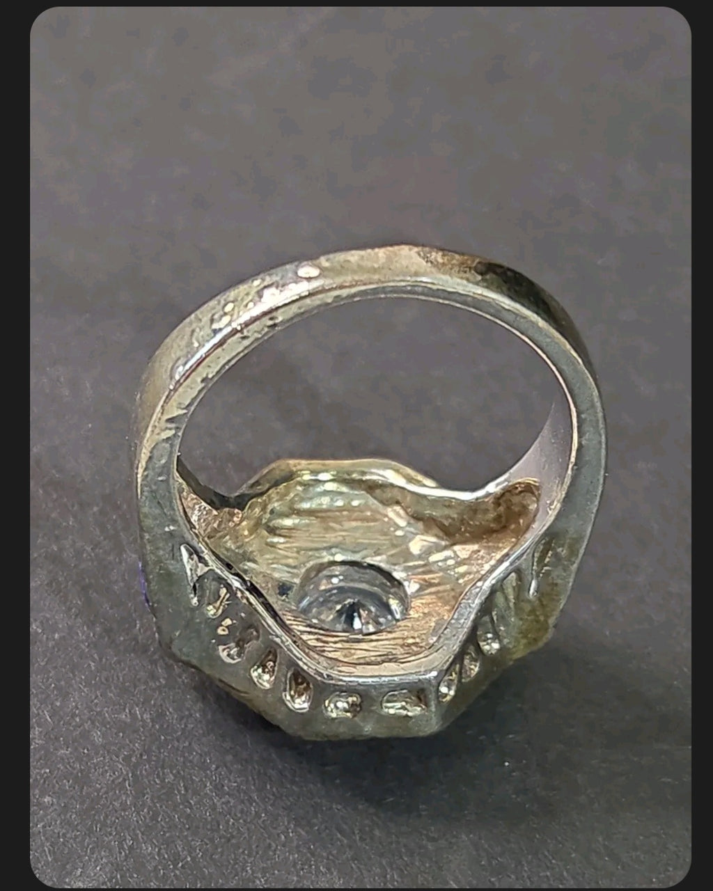 Oddly Darling Vintage ornate statement ring with textured antique finish and central stone, viewed from the side.