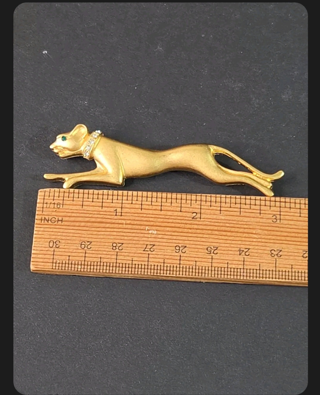 Oddly Darling Vintage panther brooch in brushed gold-tone with crystal collar and emerald green eye on a ruler