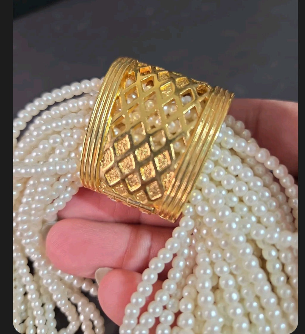 Oddly Darling Vintage multi-strand cream faux pearl necklace with a gold-tone textured lattice clasp centerpiece.