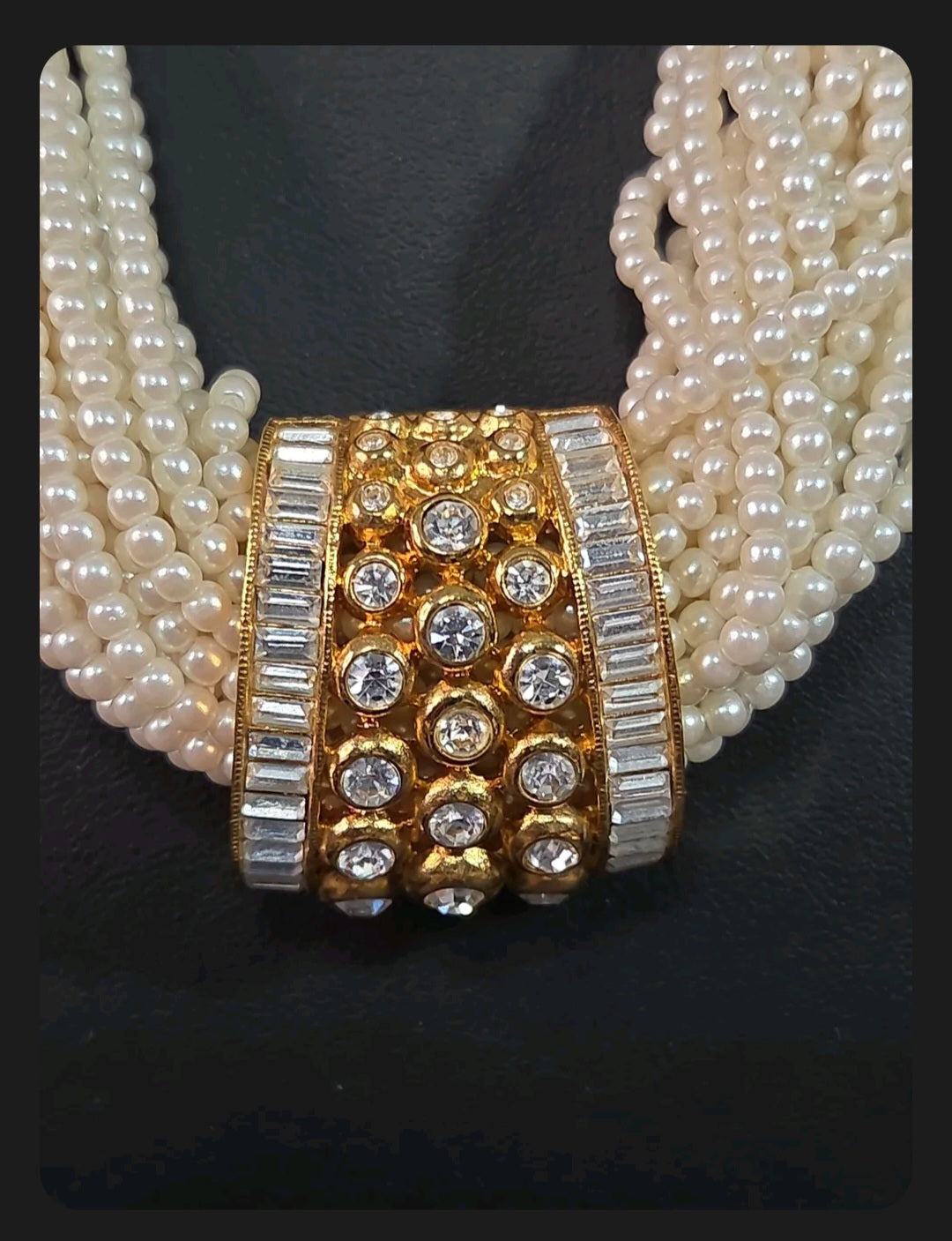 Oddly Darling Vintage multi-strand cream faux pearl necklace with a gold-tone rhinestone and crystal centerpiece.