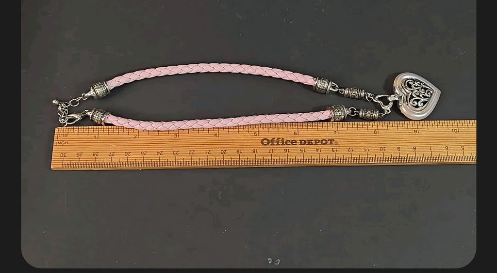 Oddly Darling Vintage heart pendant necklace with a braided light pink cord and silver filigree detailing.