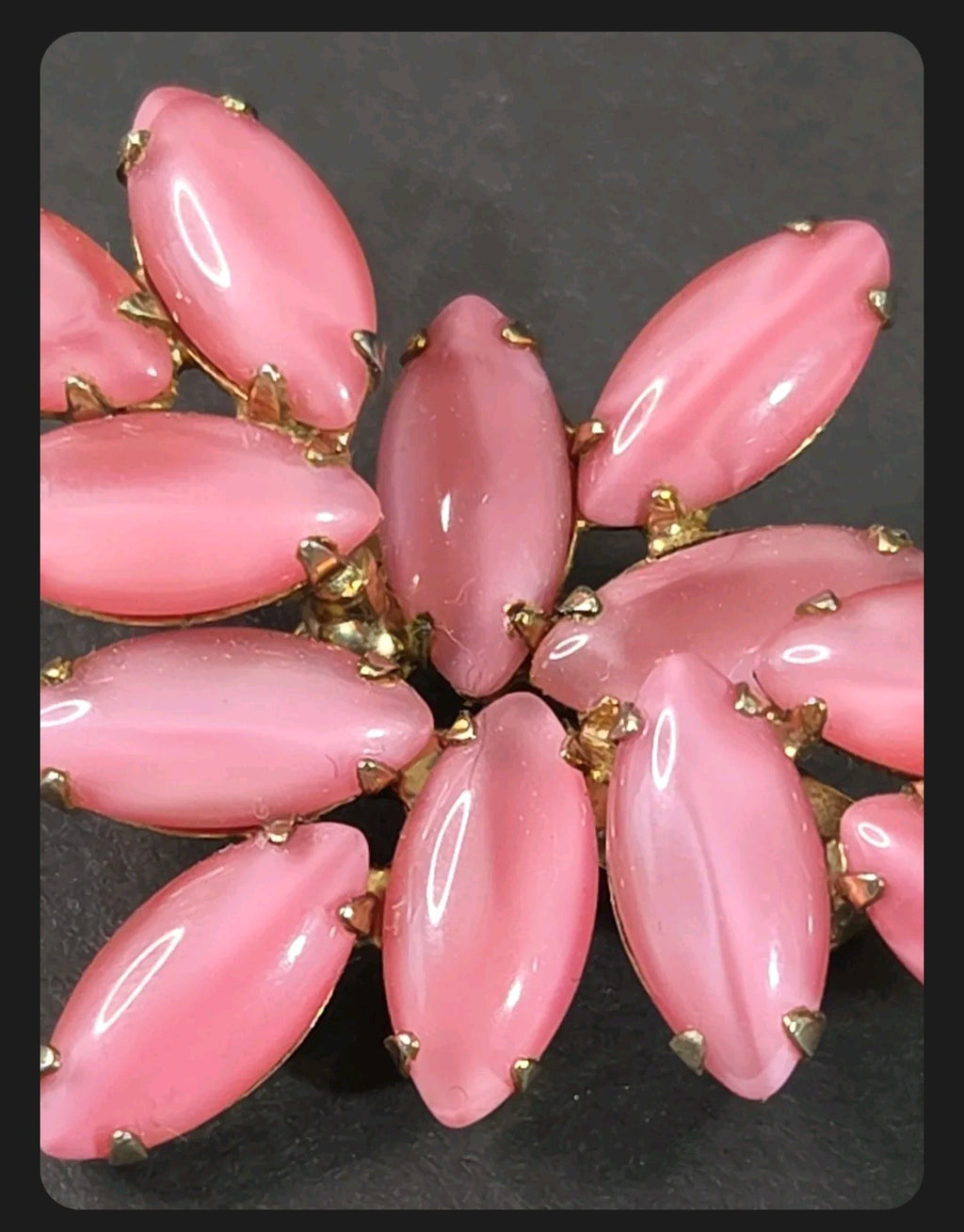 Oddly Darling Vintage brooch featuring a cluster of pastel pink marquise-cut cabochon stones in a gold-tone setting.