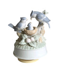 Oddly Darling Vintage porcelain music box featuring a bird family in a nest with soft pastel blue and green tones.