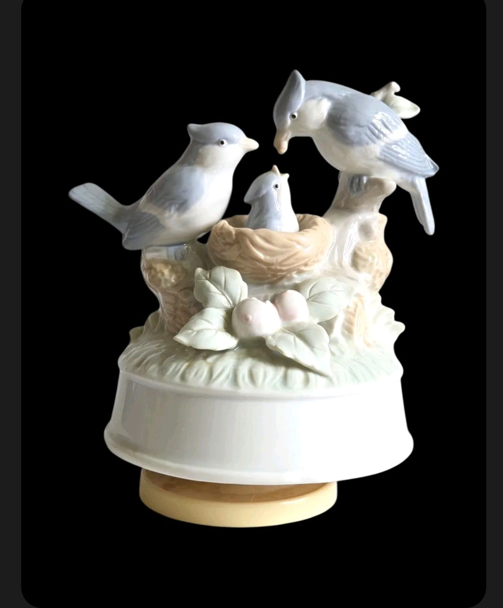 Oddly Darling Vintage porcelain music box featuring a bird family in a nest with soft pastel blue and cream tones.