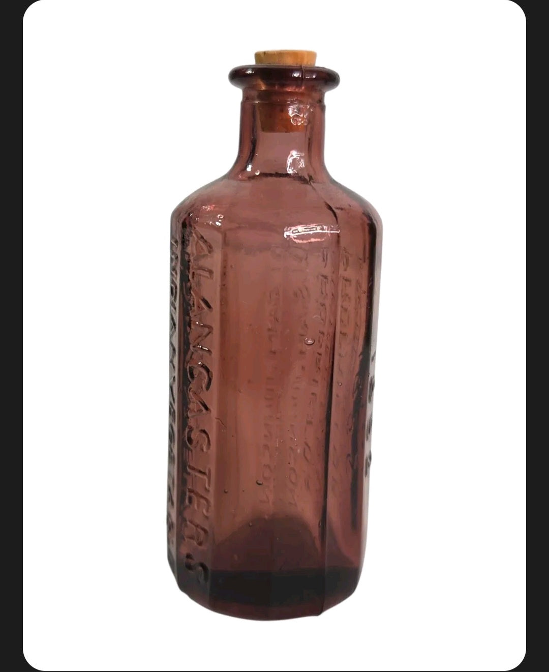 Oddly Darling Vintage purple glass apothecary bottle with embossed Lancaster's text and a cork stopper.