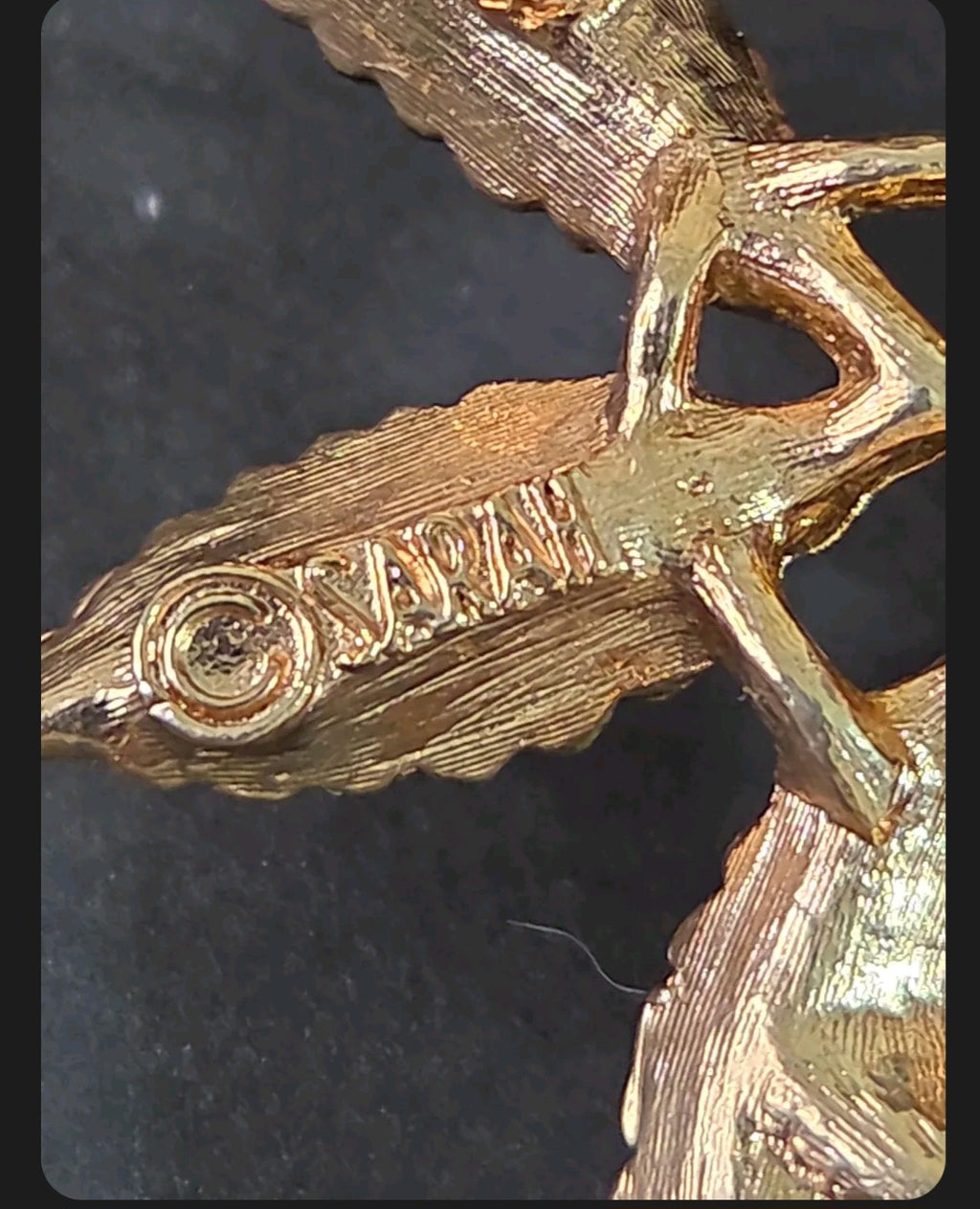 Oddly Darling Vintage SARAH floral brooch showing the detailed gold-tone textured metal hallmark on the back