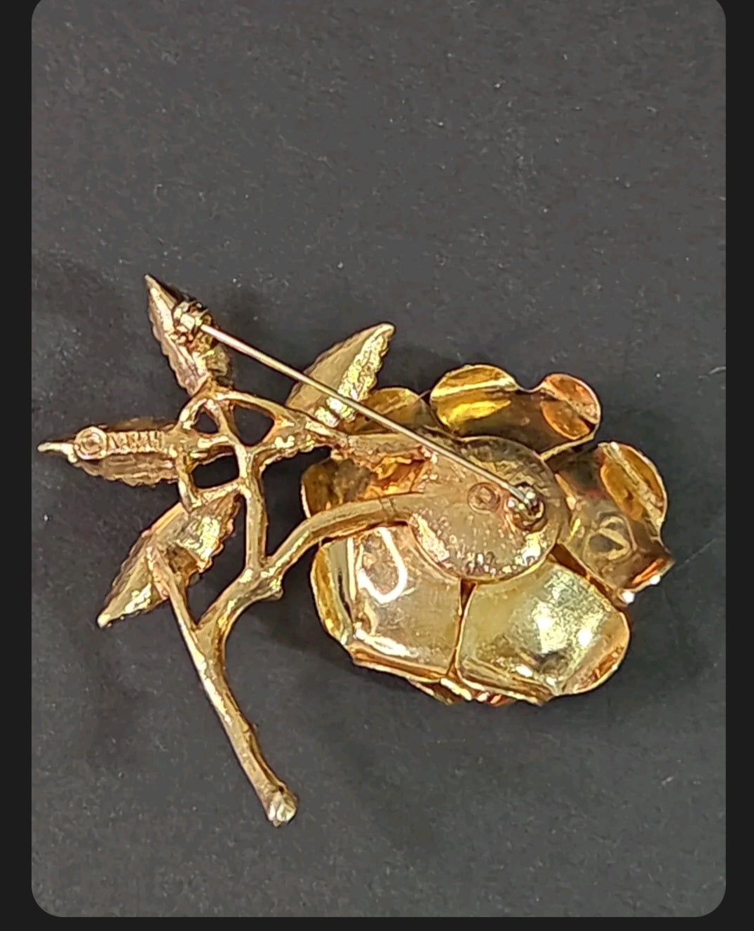Back view of an Oddly Darling Vintage SARAH gold-tone rose brooch showing the pin mechanism and textured metal finish.