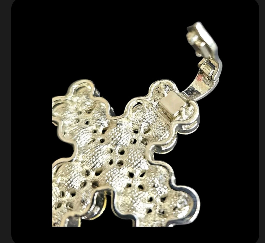 Oddly Darling Vintage silver-tone cross pendant back view showing textured metal finish and hinged bail