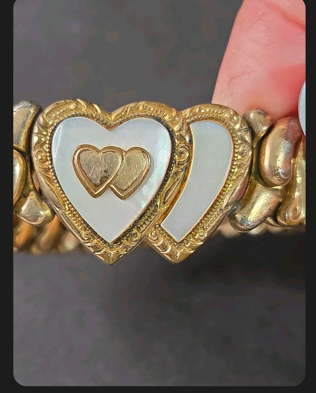 Oddly Darling Vintage Speidel expansion bracelet featuring dual heart motifs with mother-of-pearl and gold-tone detail.