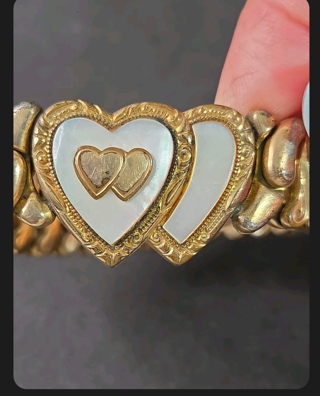 Oddly Darling Vintage Speidel expansion bracelet featuring dual heart motifs with mother-of-pearl and gold-tone detail.
