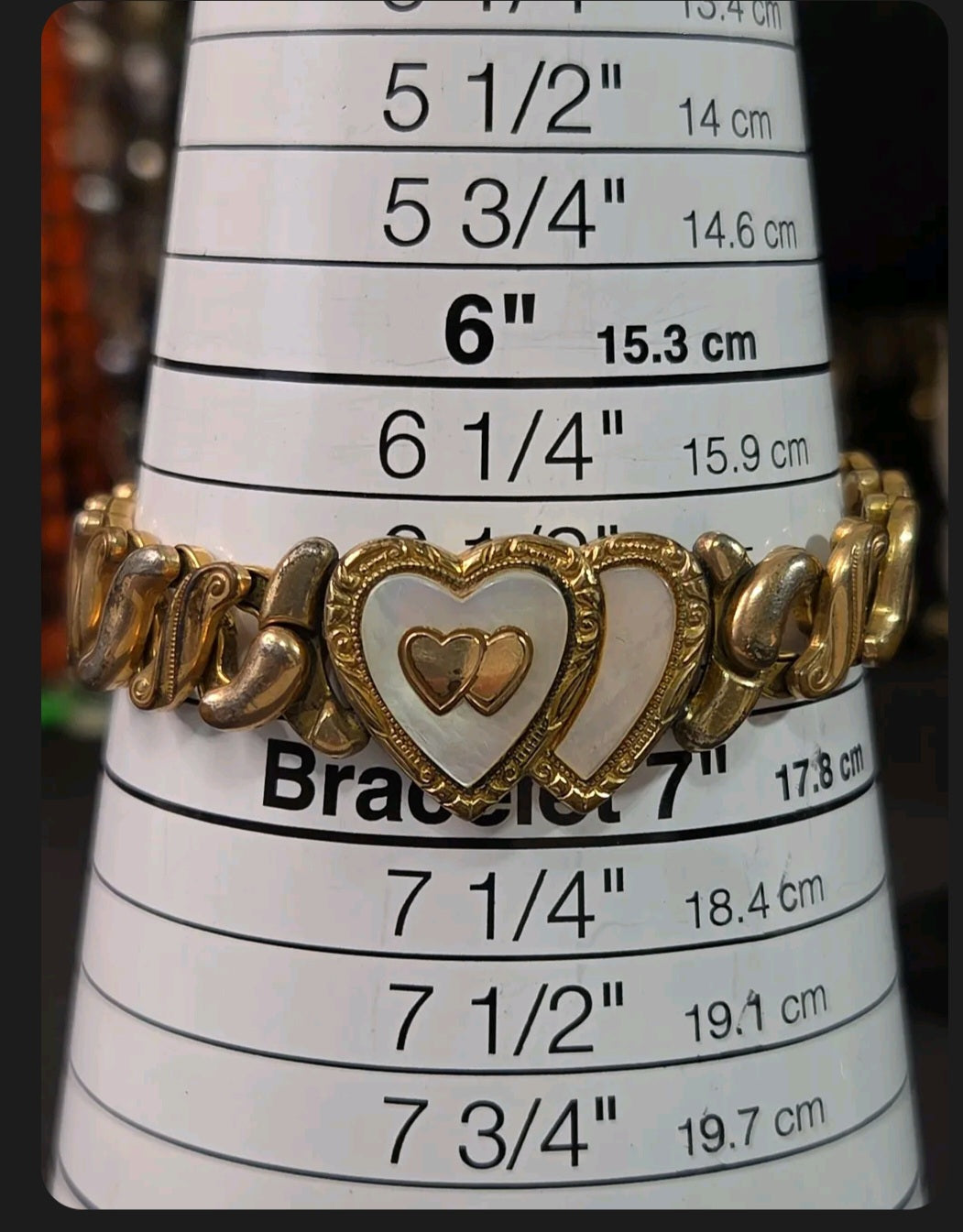 Oddly Darling Vintage Speidel gold-tone expansion bracelet featuring dual hearts with mother-of-pearl inlay on a sizer