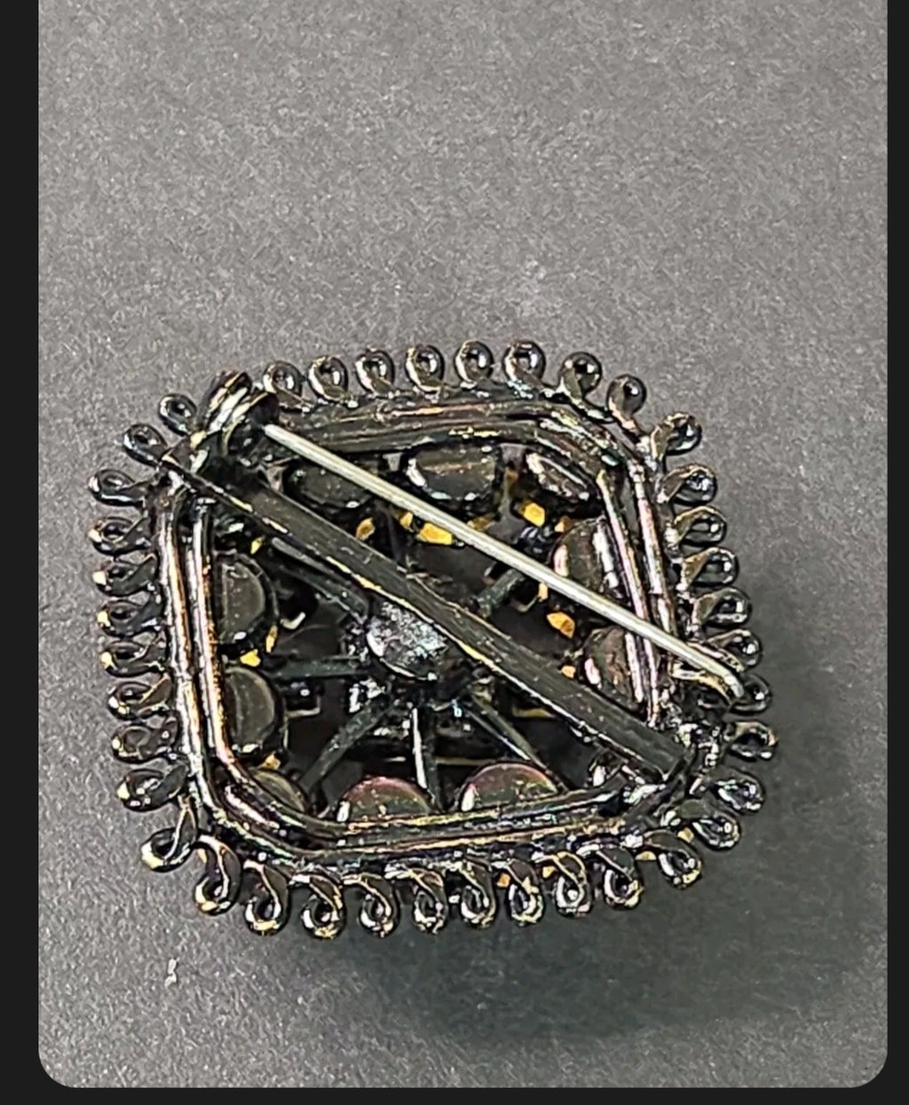 Back view of an Oddly Darling Vintage square brooch with a secure pin-back closure and dark gunmetal wirework frame.