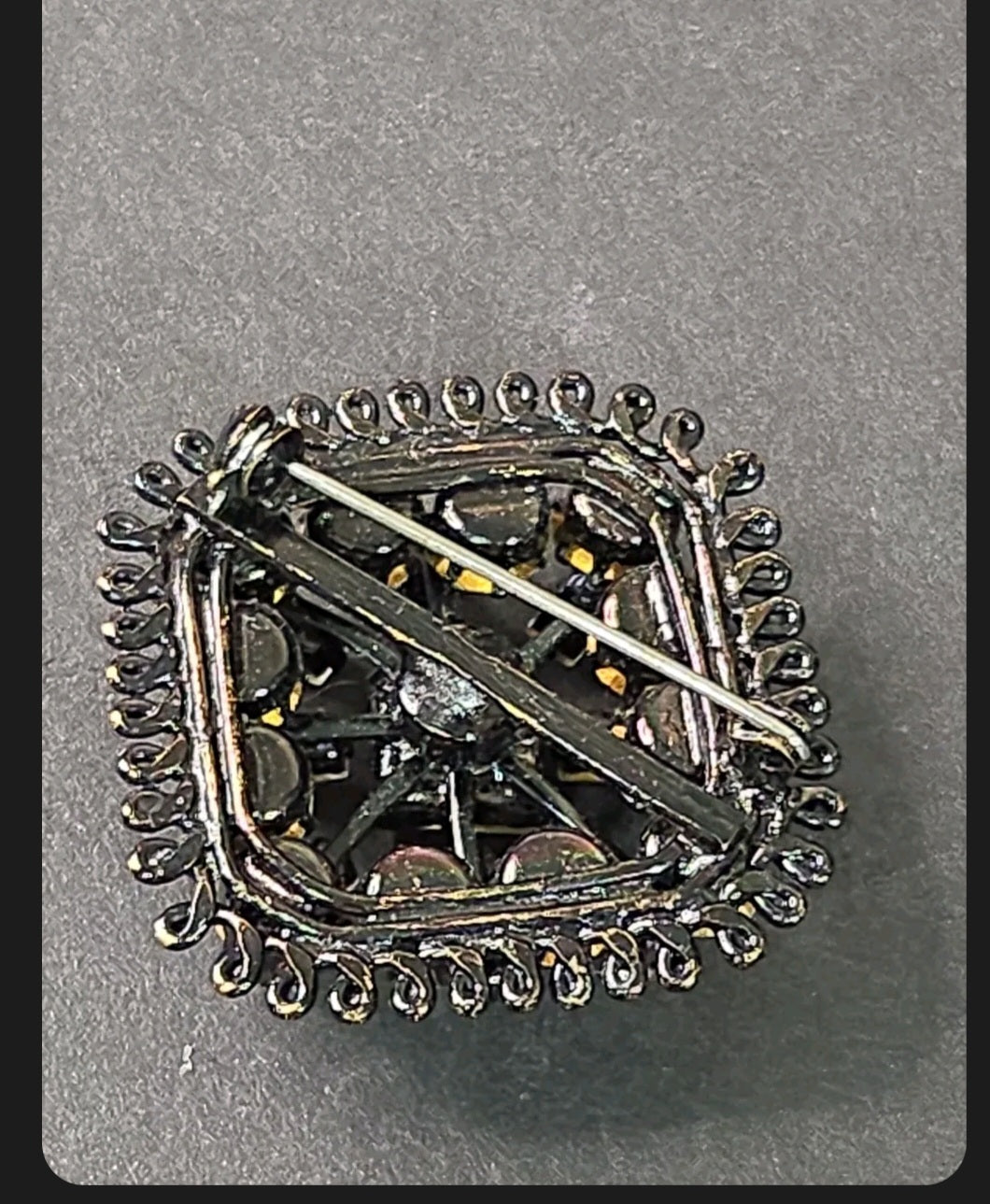 Back view of an Oddly Darling Vintage square brooch with a secure pin-back closure and dark gunmetal wirework frame.