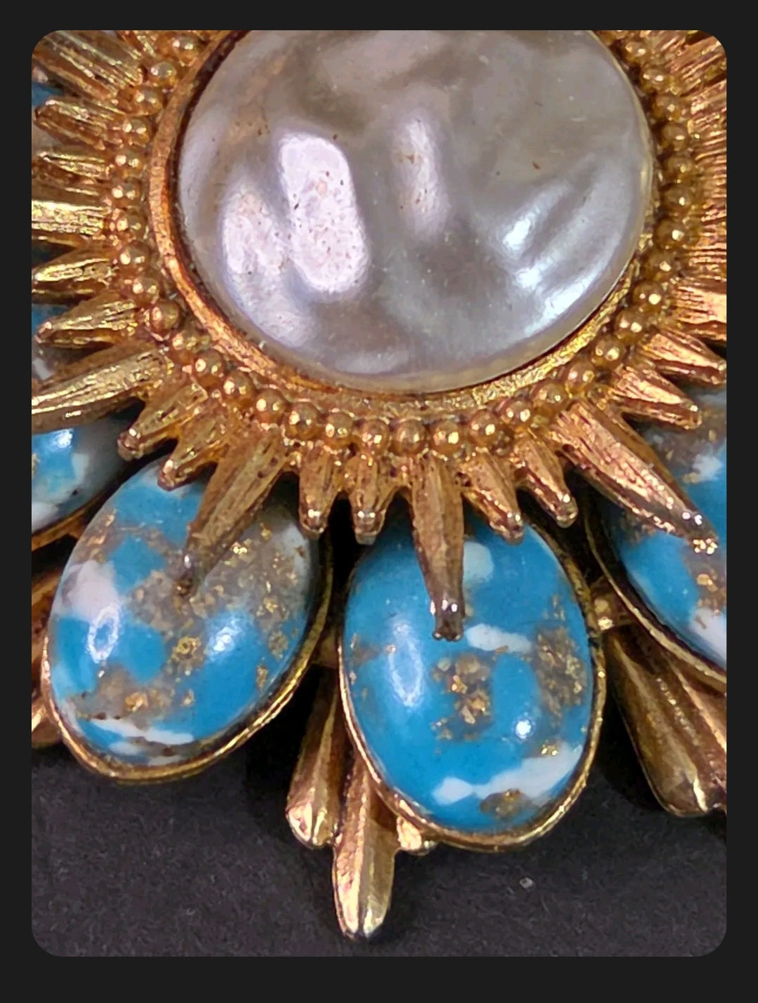 Oddly Darling Vintage sunburst brooch with a central cabochon and oval turquoise stones with gold flecks.