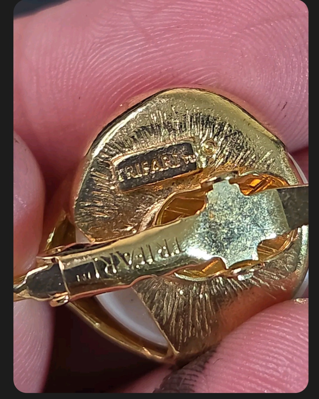 Oddly Darling Vintage Trifari clip-on earring back showing the signature stamp on the gold-tone metal setting